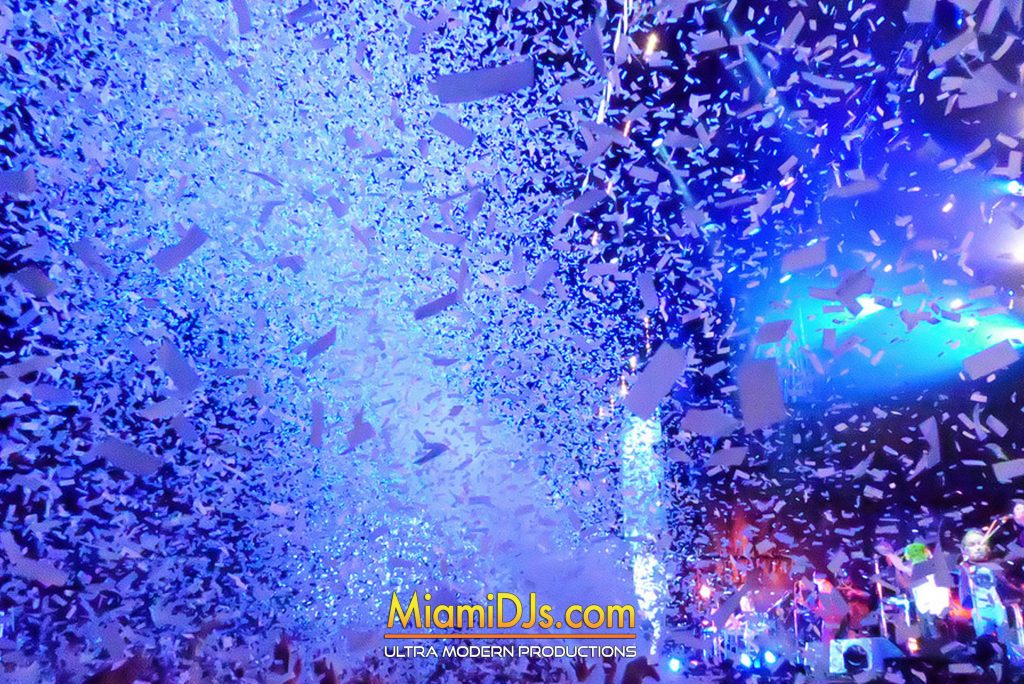 Confetti falling over a packed wedding dance floor