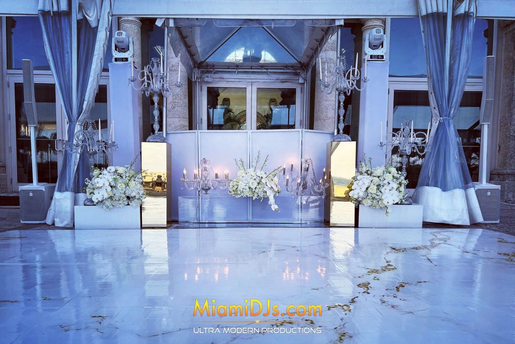 All-white wedding setup with petals on a marble floor