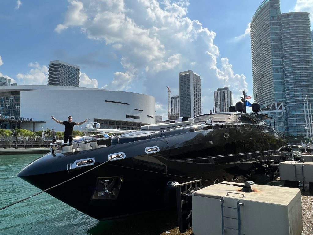 Black yacht docked on Biscayne Bay beside the arena