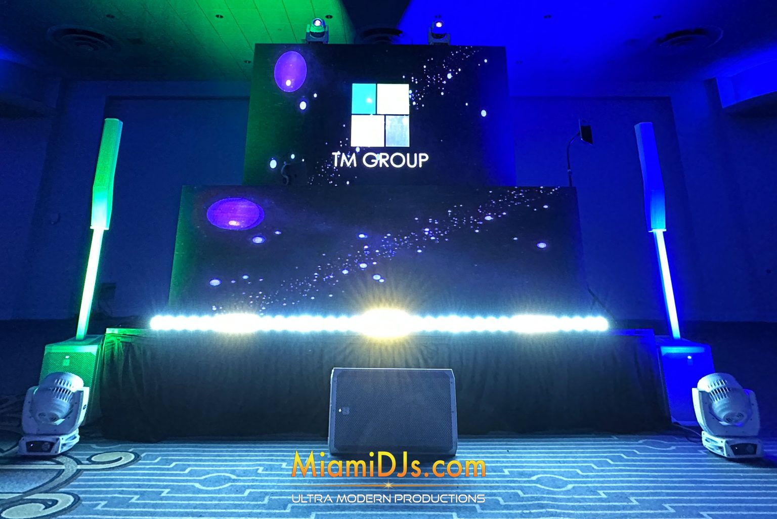 Signature corporate build with an LED booth in front and a wide LED back screen carrying the client logo