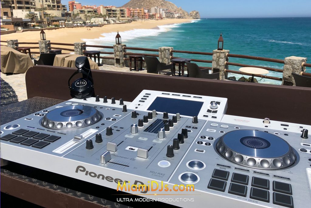Miami DJs decks set up on a restaurant terrace overlooking the beach