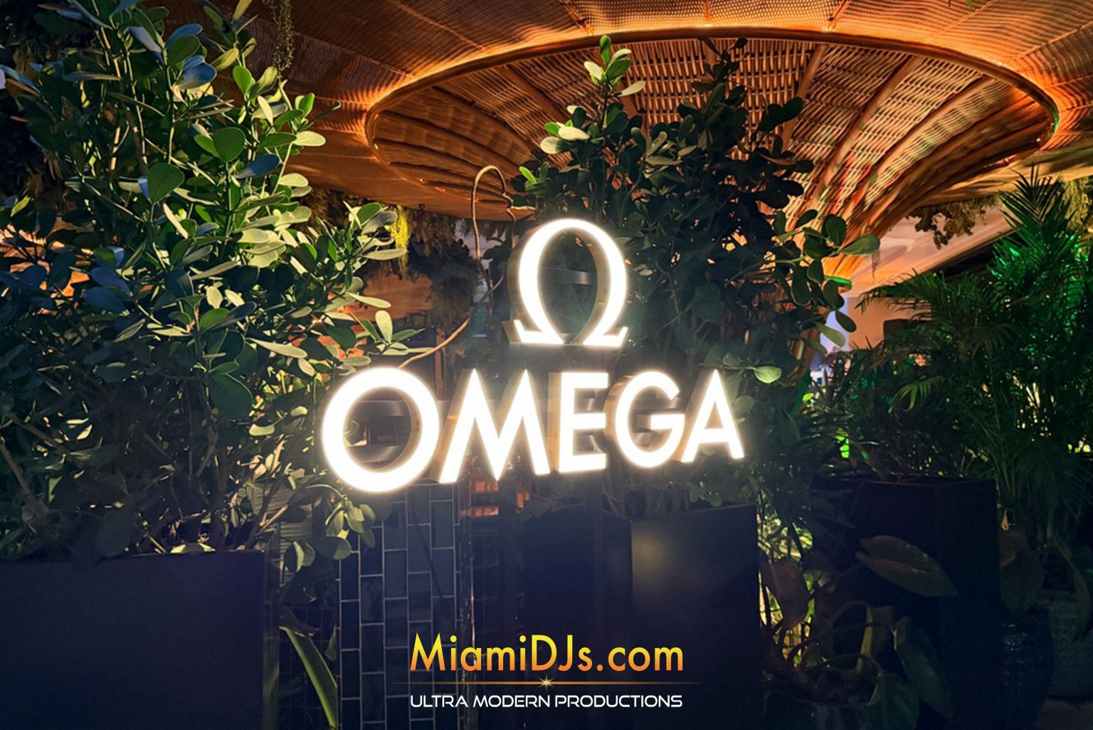 Illuminated Omega logo at a brand dinner at Amazonico Miami