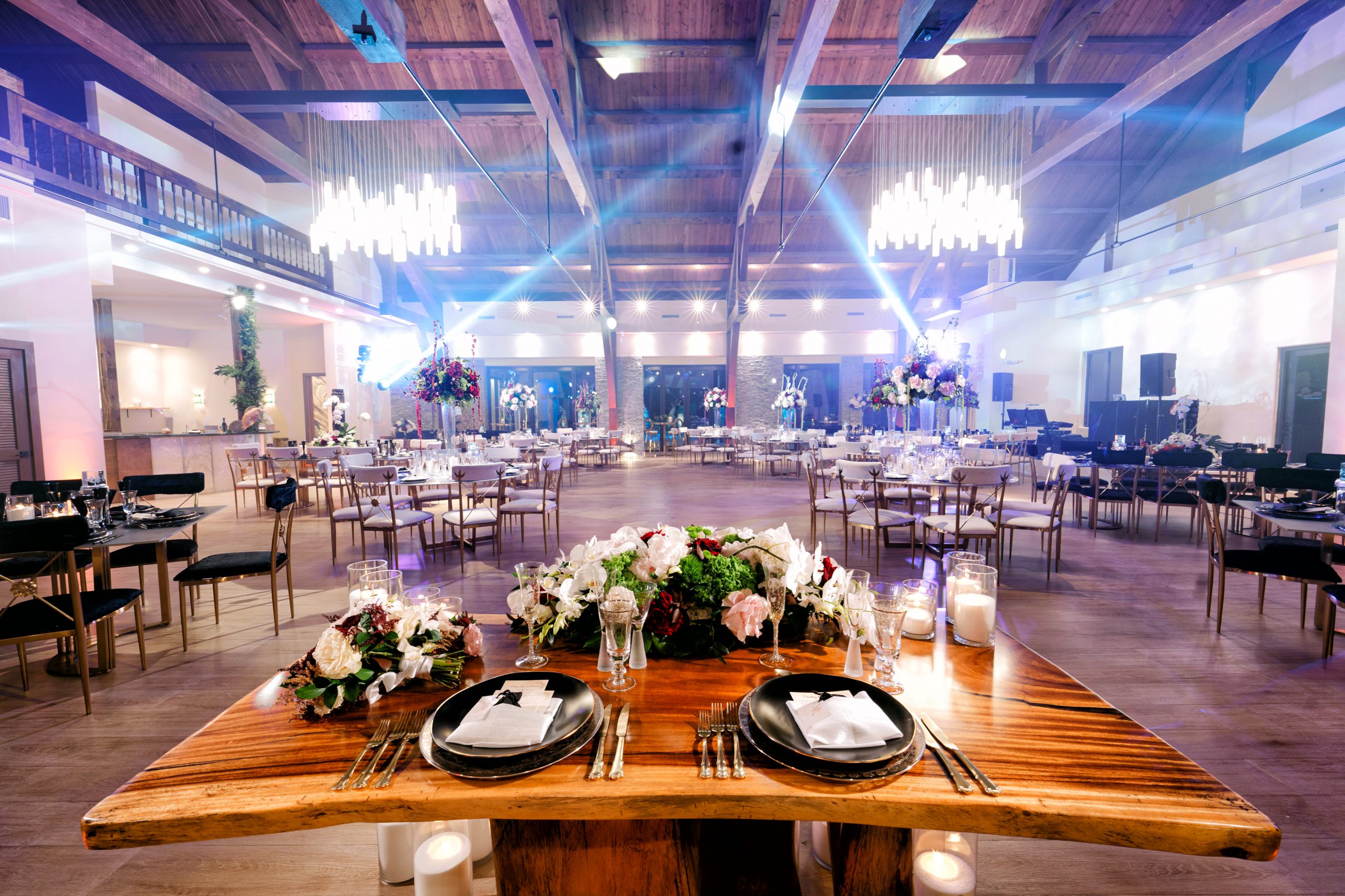 Living Sculpture Sanctuary reception hall with beam lighting and elegant table settings