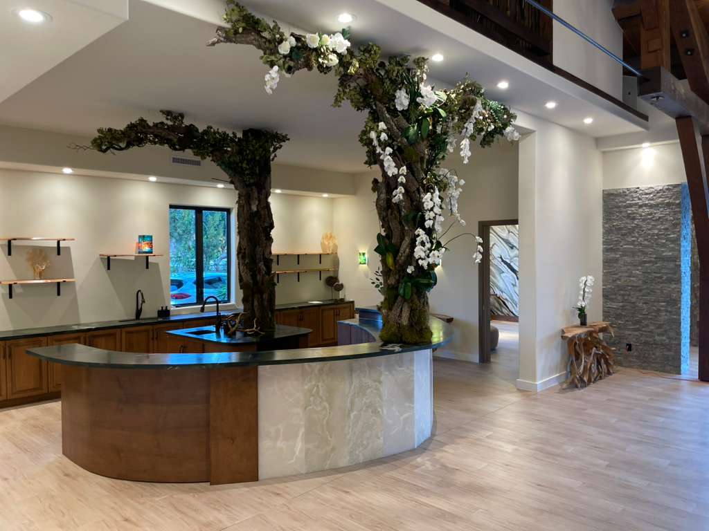 Bar area with living tree sculptures and orchids