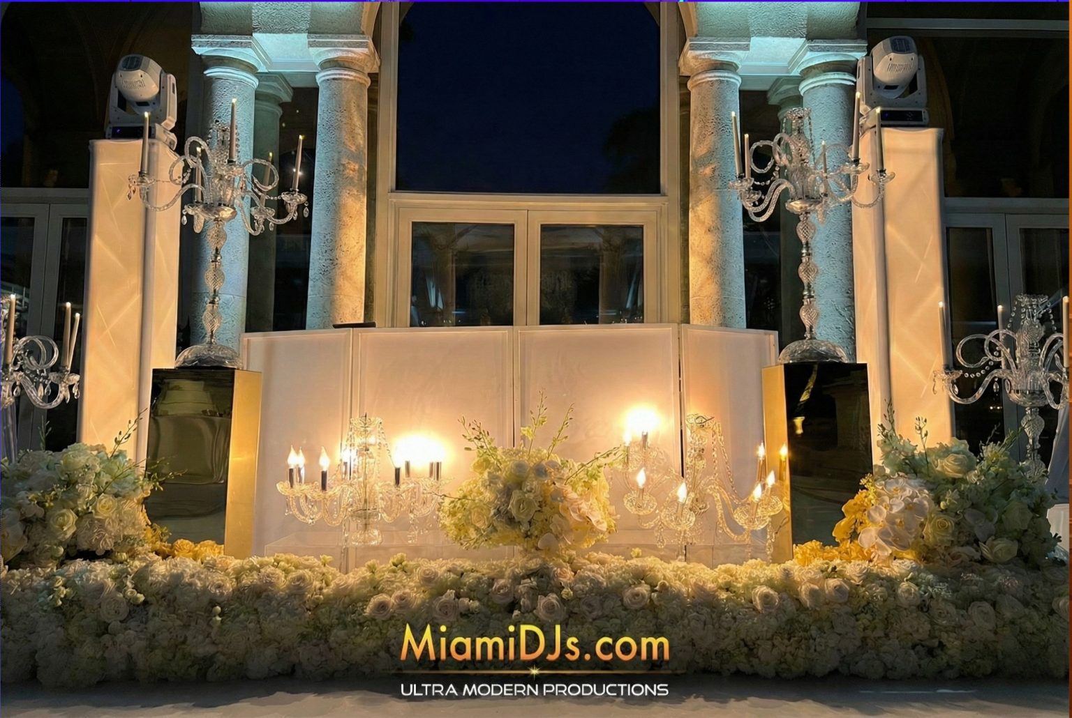 Select setup with white facade and lighting trusses at an outdoor wedding