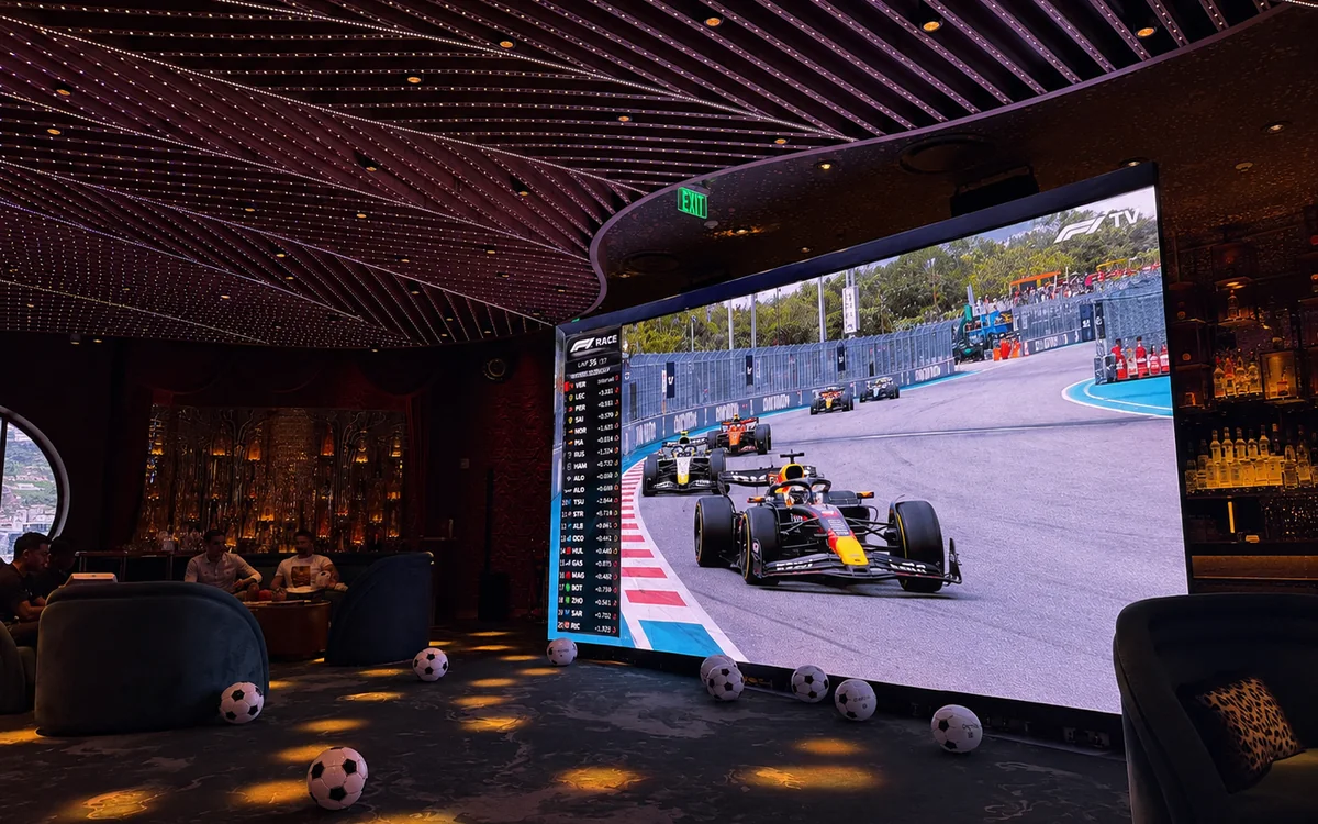 LED video wall showing the live F1 race broadcast at a Miami upscale lounge during F1 Grand Prix weekend