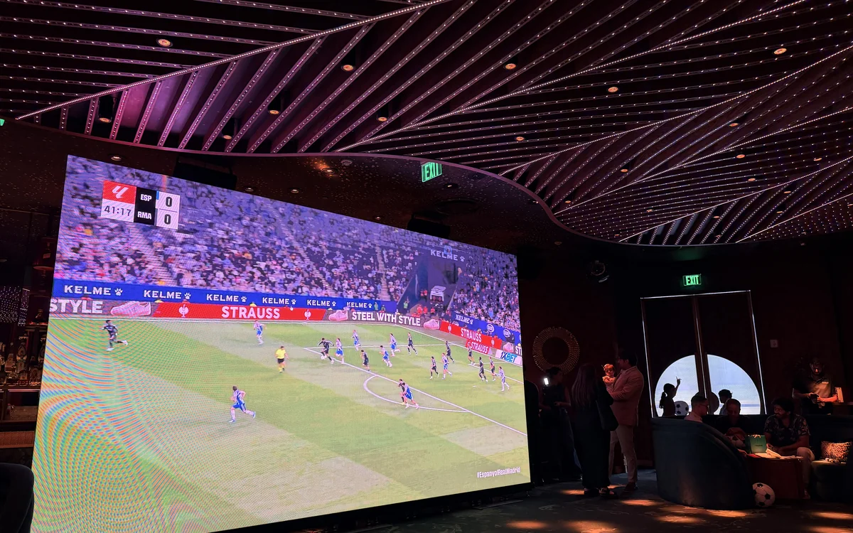 LED video wall showing a live soccer match at a Miami upscale lounge watch party, FIFA World Cup ready