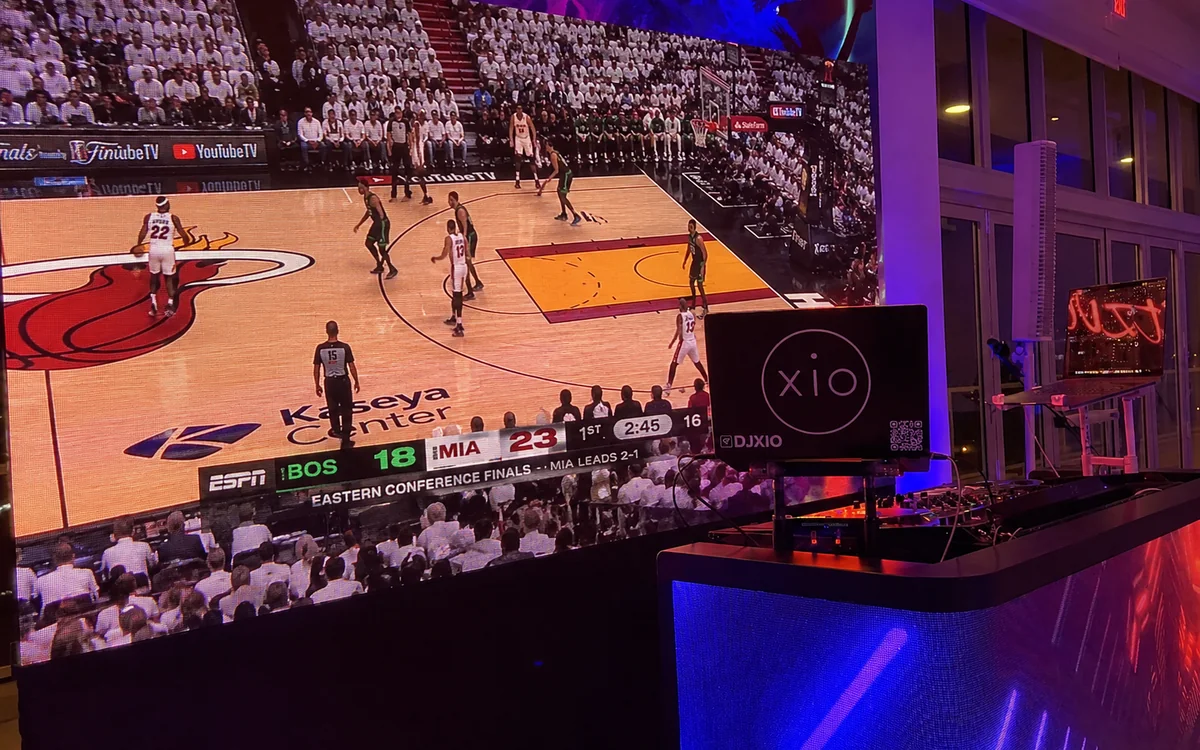 LED video wall showing a live Miami Heat playoff game with the Miami DJs LED DJ booth in the foreground
