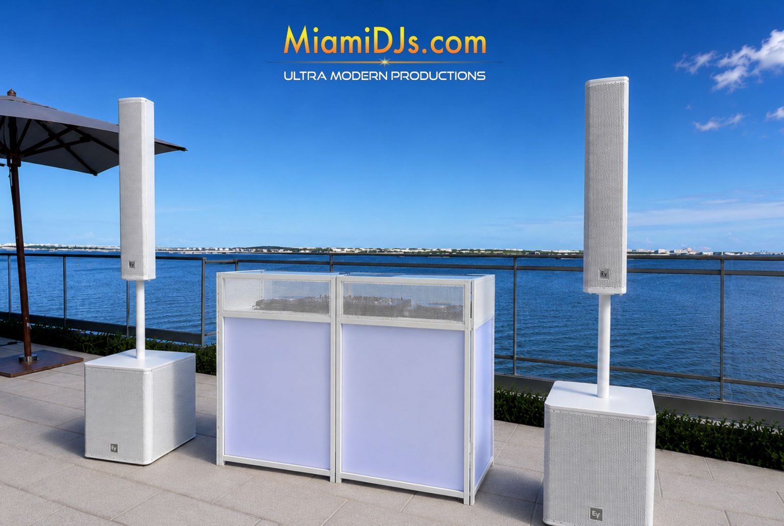 Core DJ setup with white facade and two speakers by Miami DJs