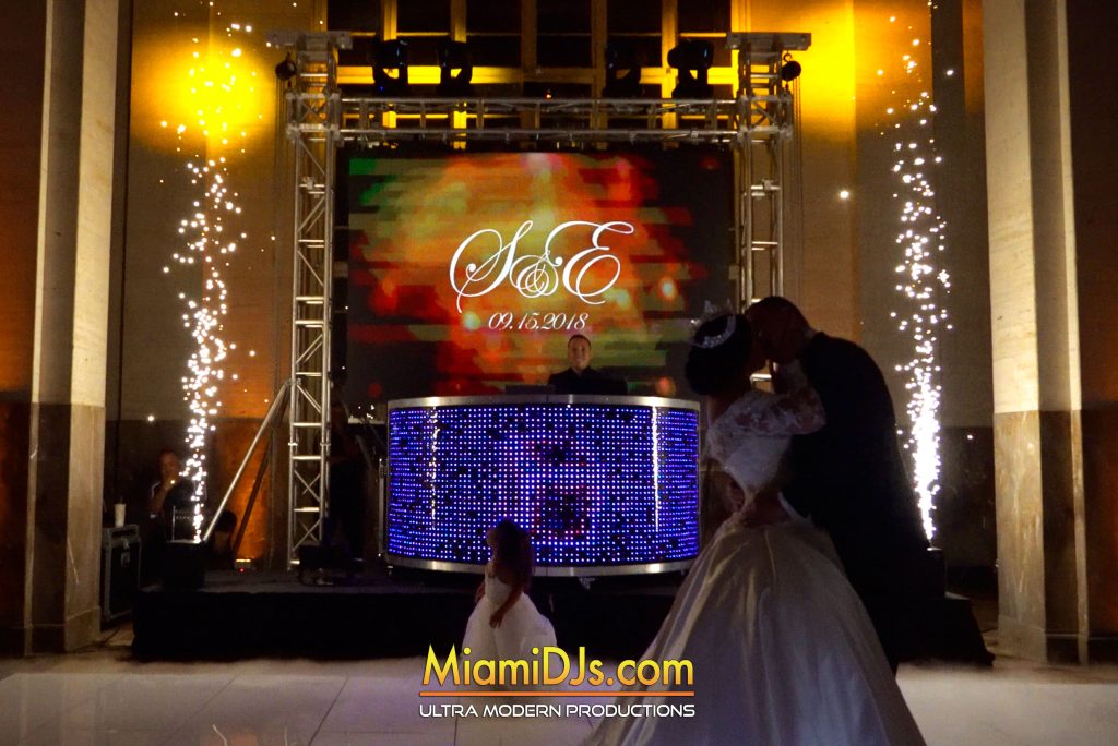 Cold spark fountains firing behind a couple on the dance floor