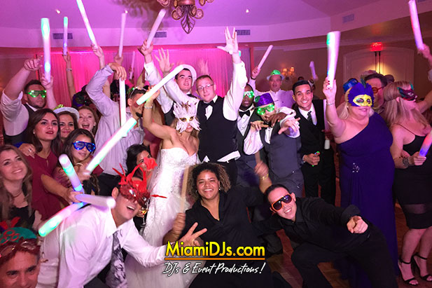 Wedding guests celebrating with the couple on the dance floor