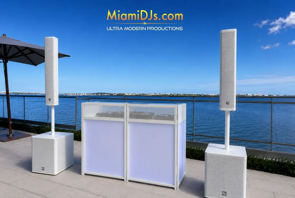 Core DJ setup with white facade by the water