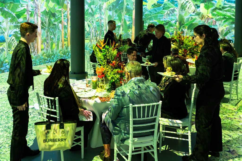 Branded outdoor brunch activation with staff in uniform and lush greenery