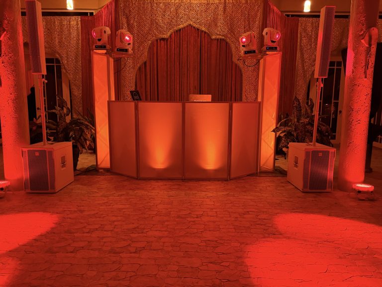 A reception room washed in deep red wireless uplighting with moving heads on the columns