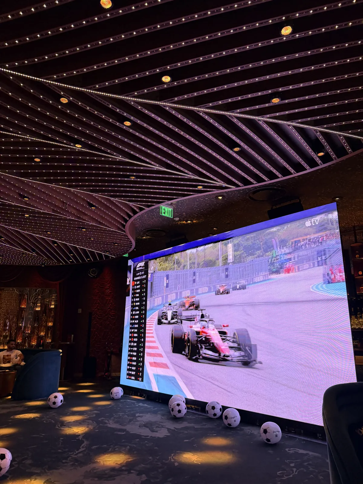 LED video wall showing the F1 Miami race at a Miami lounge watch party, built by Miami DJs
